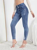 Jeans skinny strappati dettaglio bottone