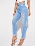 Jeans skinny strappati con vita alta