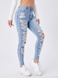 Jeans skinny con strappato con rifinitura grezza